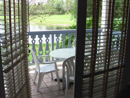 View from dining room out to the covered deck with chairs and table.