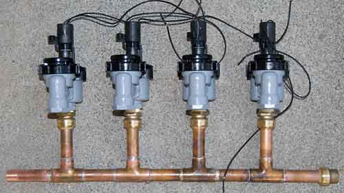 Cooper pipes with Sharkbite® fittings and anti_siphon valves attached.