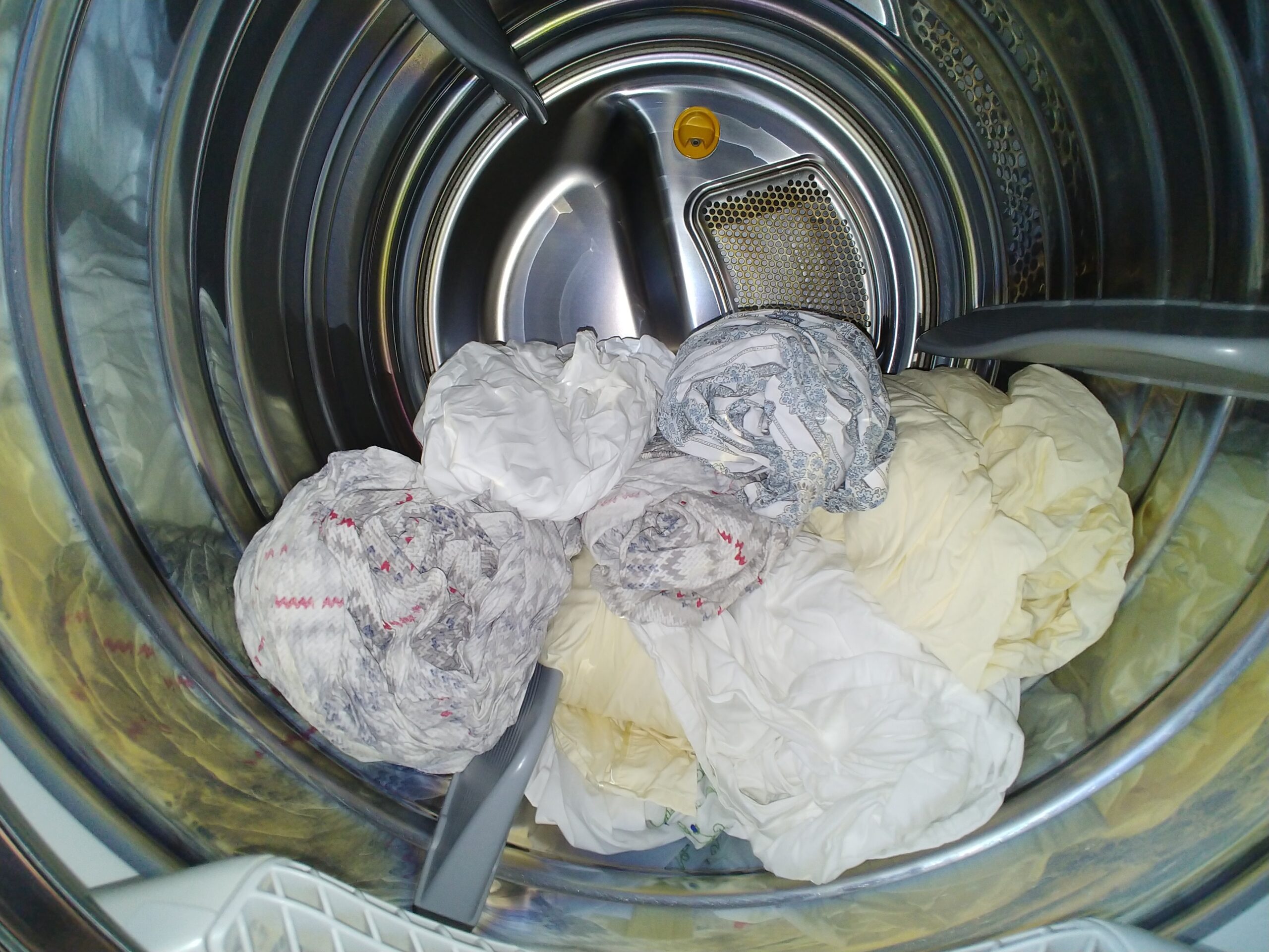 Dryer full of hand rolled bed sheets.
